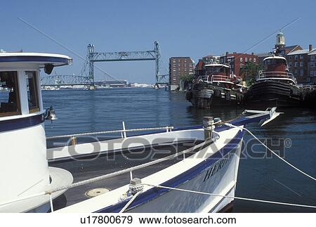 Portsmouth, NH, New Hampshire, Tugboats docked along the Piscataqua River in Portsmouth. View of Memorial Bridge crossing the Piscataqua River. View Large Photo Image Stock Photo - Portsmouth, NH, New Hampshire, Tugboats docked along the Piscataqua River in Portsmouth. View of Memorial Bridge crossing the Piscataqua River.. Fotosearch