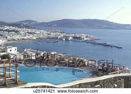 resort, swimming pool, Greece, Mykonos, Greek Islands, Cyclades, Europe, Resort with swimming pool and view of Mykonos Harbor on the Aegean Sea. View Large Photo Image Stock Image - resort, swimming pool, Greece, Mykonos, Greek Islands, Cyclades, Europe, Resort with swimming pool and view of Mykonos Harbor on the Aegean Sea.. Fotosearch