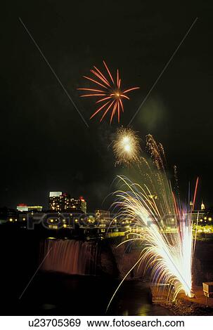 Stock Photo -  Rochester, NY, New York, Lazer & Fireworks Show at Upper Falls of the Genesee River in downtown Rochester in the evening.. Fotosearch