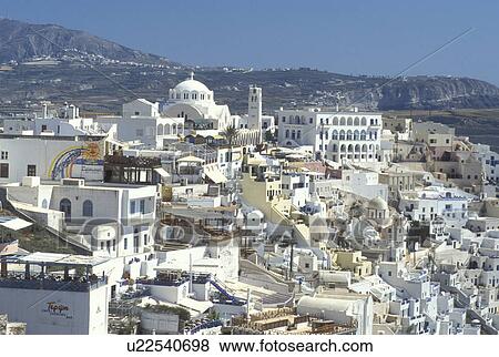 Stock Photo -  Santorini, Fira, Greece, Greek Islands, Cyclades, Europe, Whitewashed buildings in the village of Fira on the steep hillside of Santorini Island on the Aegean Sea.. Fotosearch