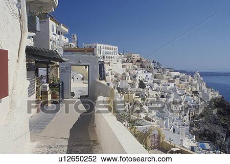 Stock Image -  Santorini, Greek Islands, Fira, Cyclades, Greece, Europe, Terraces and resorts in the village of Fira on the steep hillside of Santorini Island overlooking the Aegean Sea.. Fotosearch