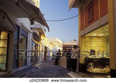 Santorini, Greek Islands, Greece, Fira, Cyclades, Europe, Shops and boutiques along a narrow pedestrian street in the village of Fira in the evening on Santorini Island on the Aegean Sea. View Large Photo Image Stock Photograph - Santorini, Greek Islands, Greece, Fira, Cyclades, Europe, Shops and boutiques along a narrow pedestrian street in the village of Fira in the evening on Santorini Island on the Aegean Sea. . Fotosearch