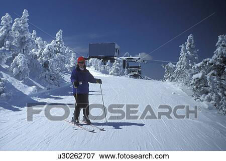 skiing, NH, New Hampshire, Franconia Notch State Park, Woman downhill skiing at Cannon Mountain Ski Resort in the White Mountains National Forest of New Hampshire in winter. View Large Photo Image Stock Photo - skiing, NH, New Hampshire, Franconia Notch State Park, Woman downhill skiing at Cannon Mountain Ski Resort in the White Mountains National Forest of New Hampshire in winter.. Fotosearch