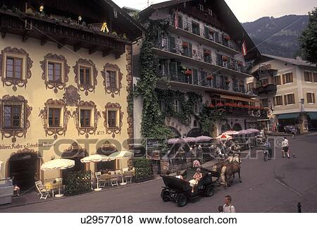 Stock Photo -  St. Wolfgang, Austria, Salzkammergut, Oberosterreich, Horse drawn carriage along the street in the resort town of Saint Wolfgang. . Fotosearch