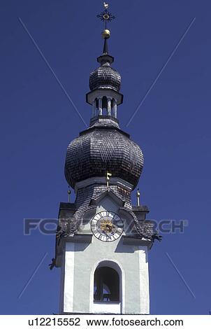 Stock Image -  steeple, church, Austria, Tirol, Church steeple in Tirol in the Austrian Alps.. Fotosearch
