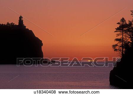 sunrise, Lake Superior, North Shore Drive, Two Harbors, MN, Minnesota, A sun rises behind Split Rock Lighthouse which is situated on a high cliff on the north shore of Lake Superior at Split Rock Lighthouse State Park in Two Harbors. View Large Photo Image Stock Photo - sunrise, Lake Superior, North Shore Drive, Two Harbors, MN, Minnesota, A sun rises behind Split Rock Lighthouse which is situated on a high cliff on the north shore of Lake Superior at Split Rock Lighthouse State Park in Two Harbors.. Fotosearch