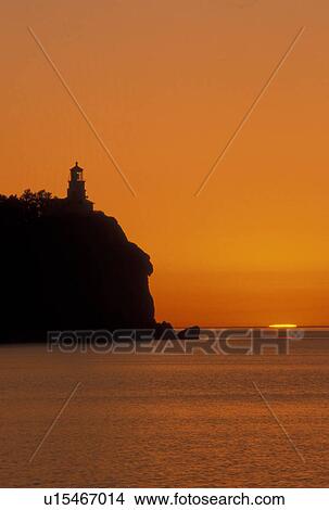 sunrise, lighthouse, Lake Superior, North Shore Drive, Two Harbors, MN, Minnesota, A sun rises behind Split Rock Lighthouse which is situated on a high cliff on the north shore of Lake Superior at Split Rock Lighthouse State Park in Two Harbors. View Large Photo Image Picture - sunrise, lighthouse, Lake Superior, North Shore Drive, Two Harbors, MN, Minnesota, A sun rises behind Split Rock Lighthouse which is situated on a high cliff on the north shore of Lake Superior at Split Rock Lighthouse State Park in Two Harbors.. Fotosearch