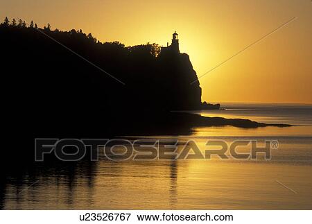 Stock Photo -  sunrise, lighthouse, Lake Superior, Two Harbors, MN, North Shore Drive, Minnesota, Split Rock Lighthouse situated on a high cliff on the north shore of Lake Superior at Split Rock Lighthouse State Park in Two Harbors at sunrise.. Fotosearch