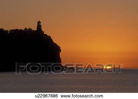 sunrise, Two Harbors, Lake Superior, MN, North Shore Drive, Minnesota, A sun rises behind Split Rock Lighthouse which is situated on a high cliff on the north shore of Lake Superior at Split Rock Lighthouse State Park in Two Harbors. View Large Photo Image Stock Photograph - sunrise, Two Harbors, Lake Superior, MN, North Shore Drive, Minnesota, A sun rises behind Split Rock Lighthouse which is situated on a high cliff on the north shore of Lake Superior at Split Rock Lighthouse State Park in Two Harbors.. Fotosearch