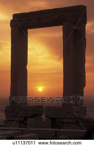 Stock Image -  sunset, Naxos, Greek Islands, Cyclades, Greece, Europe, Sun setting through the Temple of Apollo on Naxos Island on the Aegean Sea.. Fotosearch