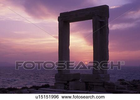 Stock Photograph -  sunset, Naxos, Greek Islands, Cyclades, Greece, Europe, Sun setting through the Temple of Apollo on Naxos Island on the Aegean Sea.. Fotosearch