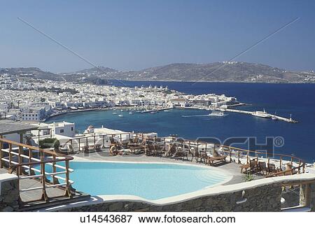 swimming pool, resort, Mykonos, Greek Islands, Cyclades, Greece, Europe, Resort with swimming pool and view of Mykonos Harbor on the Aegean Sea. View Large Photo Image Stock Photo - swimming pool, resort, Mykonos, Greek Islands, Cyclades, Greece, Europe, Resort with swimming pool and view of Mykonos Harbor on the Aegean Sea.. Fotosearch