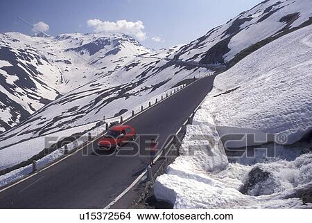 Switzerland, Alps, Uri, Furka Pass, Snow along the Furka Mountain Pass Road in the Swiss Alps in the summer. View Large Photo Image Picture - Switzerland, Alps, Uri, Furka Pass, Snow along the Furka Mountain Pass Road in the Swiss Alps in the summer.. Fotosearch