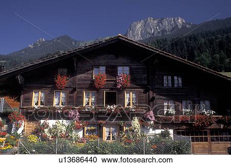 Stock Image -  Switzerland, Berne, Bern, House decorated with colorful flowers in the Simmental Valley in the Bernese Oberland.. Fotosearch