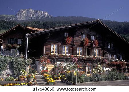 Switzerland, Berne, Bern, House decorated with colorful flowers in the Simmental Valley in the Bernese Oberland. View Large Photo Image Stock Photograph - Switzerland, Berne, Bern, House decorated with colorful flowers in the Simmental Valley in the Bernese Oberland.. Fotosearch