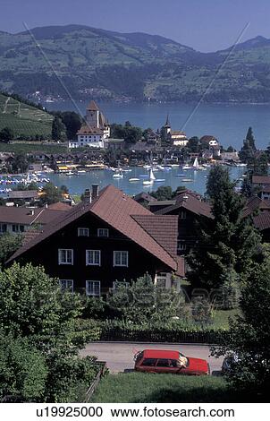 Stock Image -  Switzerland, Berne, Bern, Thunersee, Scenic view of the town of Spiez along Lake Thun in the Bernese Oberland.. Fotosearch