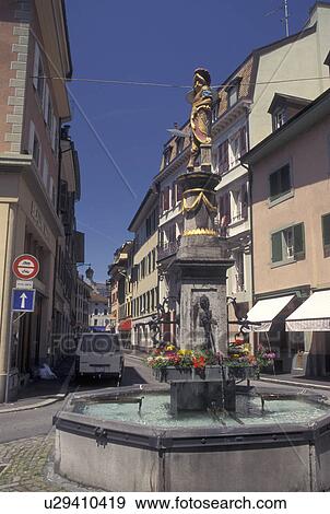 Switzerland, fountain, Vevey, Vaud, Fountain along a narrow street in downtown Vevey in the Canton of Vaud. View Large Photo Image Stock Photo - Switzerland, fountain, Vevey, Vaud, Fountain along a narrow street in downtown Vevey in the Canton of Vaud. . Fotosearch