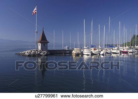 Switzerland, La Cote, Vaud, Lake Geneva, Boats docked in the harbor along the lakefront in the town of Morges on Lac Leman. View Large Photo Image Stock Image - Switzerland, La Cote, Vaud, Lake Geneva, Boats docked in the harbor along the lakefront in the town of Morges on Lac Leman.. Fotosearch