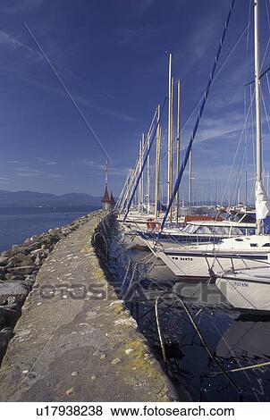 Switzerland, La Cote, Vaud, Lake Geneva, Boats docked in the harbor along the lakefront in the town of Morges on Lac Leman. View Large Photo Image Stock Photo - Switzerland, La Cote, Vaud, Lake Geneva, Boats docked in the harbor along the lakefront in the town of Morges on Lac Leman.. Fotosearch