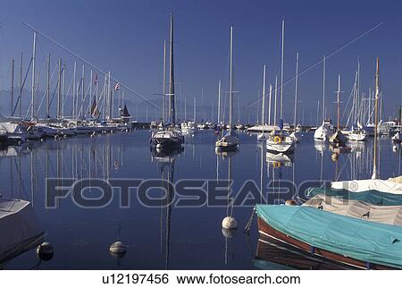 Switzerland, La Cote, Vaud, Lake Geneva, Boats docked in the harbor along the lakefront in the town of Morges on Lac Leman. View Large Photo Image Stock Photograph - Switzerland, La Cote, Vaud, Lake Geneva, Boats docked in the harbor along the lakefront in the town of Morges on Lac Leman.. Fotosearch