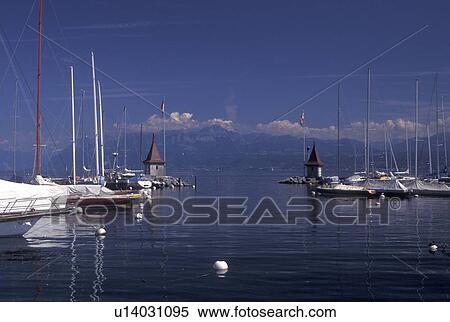 Switzerland, La Cote, Vaud, Lake Geneva, Boats docked in the harbor along the lakefront in the town of Morges on Lac Leman. View Large Photo Image Stock Photography - Switzerland, La Cote, Vaud, Lake Geneva, Boats docked in the harbor along the lakefront in the town of Morges on Lac Leman.. Fotosearch
