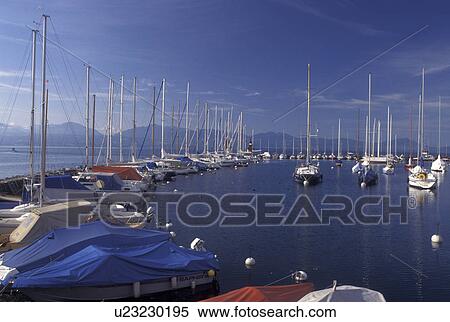 Switzerland, La Cote, Vaud, Lake Geneva, Boats docked in the harbor along the lakefront in the town of Morges on Lac Leman. View Large Photo Image Stock Photography - Switzerland, La Cote, Vaud, Lake Geneva, Boats docked in the harbor along the lakefront in the town of Morges on Lac Leman.. Fotosearch