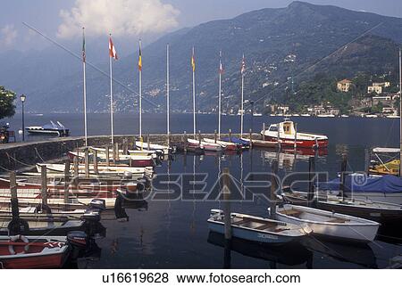 Stock Photo -  Switzerland, Ticino, Ascona, Boats docked in the harbor along the lakefront of Lake Maggiore in the city of Ascona.. Fotosearch