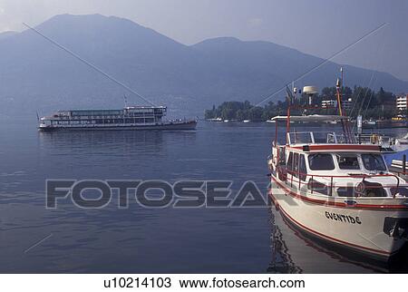 Switzerland, Ticino, Locarno, Excursion boat cruises along Lake Maggiore in the city of Locarno. View Large Photo Image Stock Image - Switzerland, Ticino, Locarno, Excursion boat cruises along Lake Maggiore in the city of Locarno.. Fotosearch