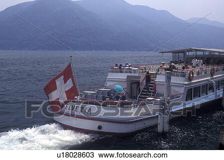 Switzerland, Ticino, Melide, Lake Lugano, Excursion boat leaves the dock in Melide on Lake Lugano. View Large Photo Image Stock Image - Switzerland, Ticino, Melide, Lake Lugano, Excursion boat leaves the dock in Melide on Lake Lugano.. Fotosearch