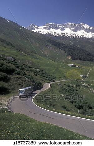 Switzerland, Uri, Alps, Furka Pass, A bus travels up the winding Furka Mountain Pass in the Swiss Alps. View Large Photo Image Stock Photo - Switzerland, Uri, Alps, Furka Pass, A bus travels up the winding Furka Mountain Pass in the Swiss Alps.. Fotosearch