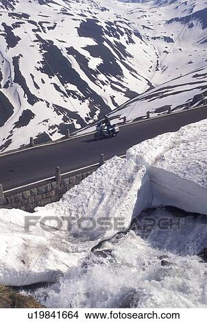 Switzerland, Uri, Alps, Furka Pass, Snow along the Furka Mountain Pass Road in the Swiss Alps in the summer. View Large Photo Image Picture - Switzerland, Uri, Alps, Furka Pass, Snow along the Furka Mountain Pass Road in the Swiss Alps in the summer.. Fotosearch