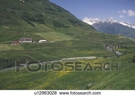 Switzerland, Uri, Urseren, Alps, Scenic view of the valley near the village of Hospental in the Swiss Alps. View Large Photo Image Stock Photo - Switzerland, Uri, Urseren, Alps, Scenic view of the valley near the village of Hospental in the Swiss Alps.. Fotosearch
