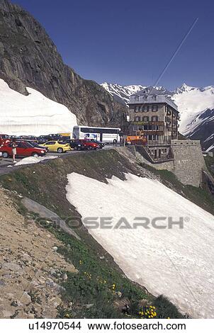 Switzerland, Valais, Alps, Furka Pass, Belvedere Restaurant in the snow at the summit of the Furka Mountain Pass Road in the Swiss Alps in the summer. View Large Photo Image Picture - Switzerland, Valais, Alps, Furka Pass, Belvedere Restaurant in the snow at the summit of the Furka Mountain Pass Road in the Swiss Alps in the summer.. Fotosearch