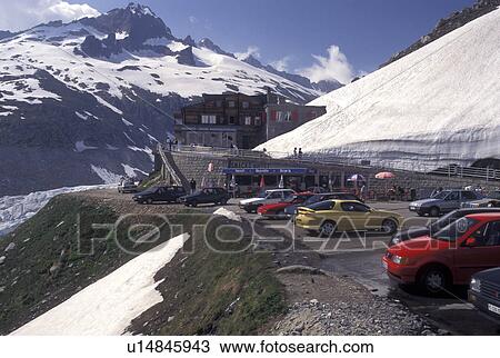 Switzerland, Valais, Alps, Furka Pass, Belvedere Restaurant in the snow at the summit of the Furka Mountain Pass Road in the Swiss Alps in the summer. View Large Photo Image Stock Image - Switzerland, Valais, Alps, Furka Pass, Belvedere Restaurant in the snow at the summit of the Furka Mountain Pass Road in the Swiss Alps in the summer.. Fotosearch