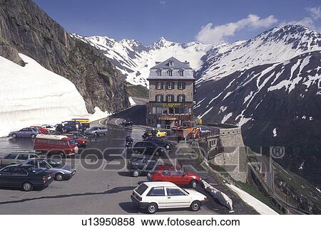 Stock Photo -  Switzerland, Valais, Alps, Furka Pass, Belvedere Restaurant in the snow at the summit of the Furka Mountain Pass Road in the Swiss Alps in the summer.. Fotosearch
