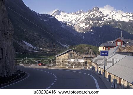 Switzerland, Valais, Alps, The mountain road winds through Gletsch in the Canton of Valais in the Swiss Alps. View Large Photo Image Stock Photograph - Switzerland, Valais, Alps, The mountain road winds through Gletsch in the Canton of Valais in the Swiss Alps.. Fotosearch