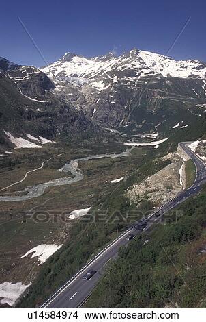 Switzerland, Valais, Rhone River, Furka Pass, Alps, Furka Mountain Pass Road winds through the Swiss Alps in the Canton of Valais. View Large Photo Image Picture - Switzerland, Valais, Rhone River, Furka Pass, Alps, Furka Mountain Pass Road winds through the Swiss Alps in the Canton of Valais.. Fotosearch