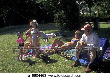 Switzerland, Vaud, Lake Geneva, La Cote, A family enjoying a day in the sun on the beach in Perroy along Lac Leman in the Canton of Vaud. View Large Photo Image Stock Image - Switzerland, Vaud, Lake Geneva, La Cote, A family enjoying a day in the sun on the beach in Perroy along Lac Leman in the Canton of Vaud.. Fotosearch