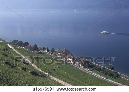 Switzerland, Vaud, Lavaux, Lake Geneva, Scenic view of an excursion steamer boat cruising along the lakeshore of Lac Leman from the steep slopes of the vineyards of Lavaux in the Canton of Vaud. View Large Photo Image Stock Image - Switzerland, Vaud, Lavaux, Lake Geneva, Scenic view of an excursion steamer boat cruising along the lakeshore of Lac Leman from the steep slopes of the vineyards of Lavaux in the Canton of Vaud. . Fotosearch