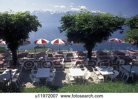 Switzerland, Vaud, Lavaux, Lake Geneva, Alps, Outdoor cafT on a terrace in Chexbres overlooking Lac Leman in the Canton of Vaud. Scenic view of the Alps across Lake Geneva. View Large Photo Image Stock Photo - Switzerland, Vaud, Lavaux, Lake Geneva, Alps, Outdoor cafT on a terrace in Chexbres overlooking Lac Leman in the Canton of Vaud. Scenic view of the Alps across Lake Geneva.. Fotosearch