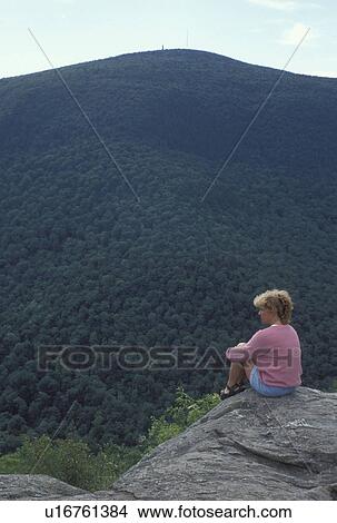 Taconic Range, North Adams, MA, Massachusetts, Mt. Greylock, Woman sitting a overlook on the summit of Mount Greylock looking out at Taconic Range from Mount Greylock State Reservation. View Large Photo Image Picture - Taconic Range, North Adams, MA, Massachusetts, Mt. Greylock, Woman sitting a overlook on the summit of Mount Greylock looking out at Taconic Range from Mount Greylock State Reservation.. Fotosearch