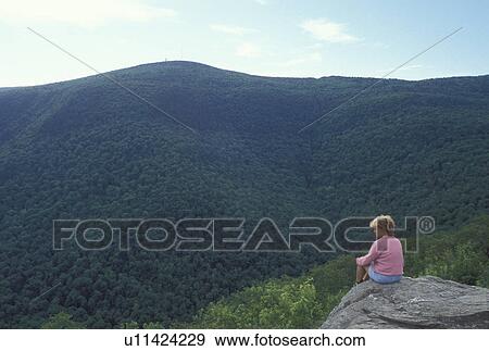 Taconic Range, North Adams, MA, Massachusetts, Mt. Greylock, Woman sitting a overlook on the summit of Mount Greylock looking out at Taconic Range from Mount Greylock State Reservation. View Large Photo Image Stock Photo - Taconic Range, North Adams, MA, Massachusetts, Mt. Greylock, Woman sitting a overlook on the summit of Mount Greylock looking out at Taconic Range from Mount Greylock State Reservation.. Fotosearch