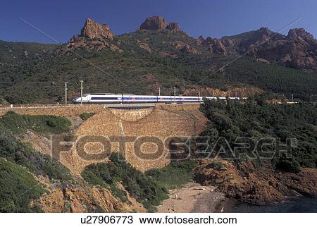 TGV, France, Massif de l' Esterel, Cote d' Azur, Provence, Var, Europe, The TGV high-speed train travels along the red rocky coastline of the Corniche de l' Esterel on the Mediterranean Sea. View Large Photo Image Stock Image - TGV, France, Massif de l' Esterel, Cote d' Azur, Provence, Var, Europe, The TGV high-speed train travels along the red rocky coastline of the Corniche de l' Esterel on the Mediterranean Sea.. Fotosearch