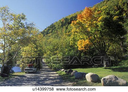 The Adirondacks, NY, Lake Placid, New York, White car with red canoe parked at picnic area in Lake Placid in the autumn. View Large Photo Image Stock Photo - The Adirondacks, NY, Lake Placid, New York, White car with red canoe parked at picnic area in Lake Placid in the autumn. . Fotosearch