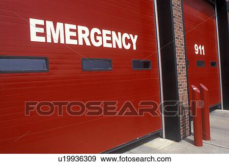Stock Photo -  Thunder Bay, Canada, Ontario, Emergency and 911 on the red doors of a firestation. . Fotosearch