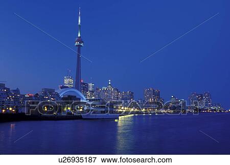 Stock Photo -  Toronto, Canada, Ontario, Lake Ontario, CN Tower and skyline of downtown Toronto in the evening along Toronto Inner Harbor on Lake Ontario.. Fotosearch