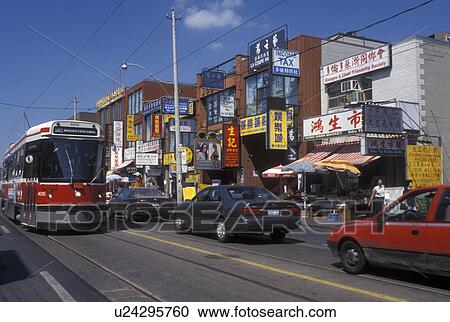 Stock Image -  Toronto, Canada, Ontario, Trolley runs along the Dundas Street and Chinatown in downtown Toronto. . Fotosearch