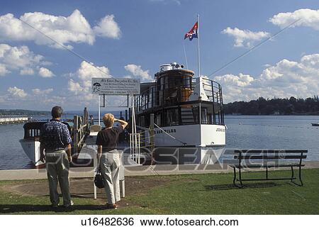Stock Photograph -  tour boat, Skaneateles, NY, New York, Skaneateles Lake, Finger Lakes, The Judge Ben Wiles sightseeing dinner cruise boat docked in the harbor of Skaneateles Lake in the Finger Lakes Region.. Fotosearch