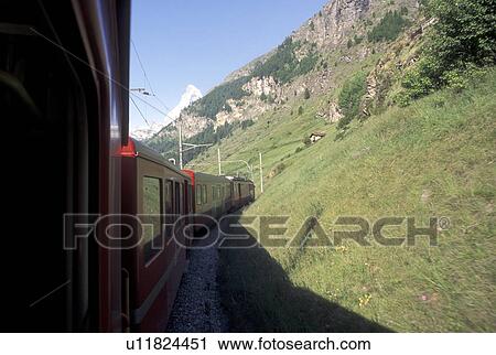 train, Switzerland, Valais, Alps, The red Tasch-Zermatt train travels to the village of Zermatt in the Canton of Valais in the Swiss Alps. View Large Photo Image Stock Image - train, Switzerland, Valais, Alps, The red Tasch-Zermatt train travels to the village of Zermatt in the Canton of Valais in the Swiss Alps.. Fotosearch