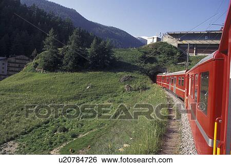 train, Switzerland, Valais, Alps, The red Tasch-Zermatt train travels to the village of Zermatt in the Canton of Valais in the Swiss Alps. View Large Photo Image Stock Photograph - train, Switzerland, Valais, Alps, The red Tasch-Zermatt train travels to the village of Zermatt in the Canton of Valais in the Swiss Alps.. Fotosearch